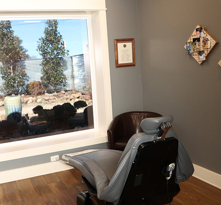 dental chair in operatory at Magnolia Dental in Mabank, looking out over a peaceful rock garden.