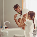 oral health routine, father brushing teeth with daughter, healthy smile, healthy teeth