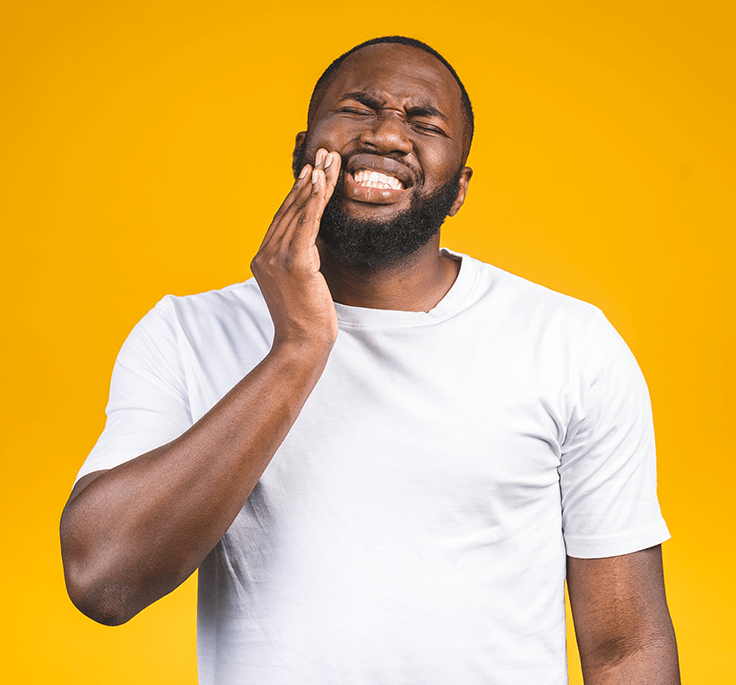 man holding his jaw in pain