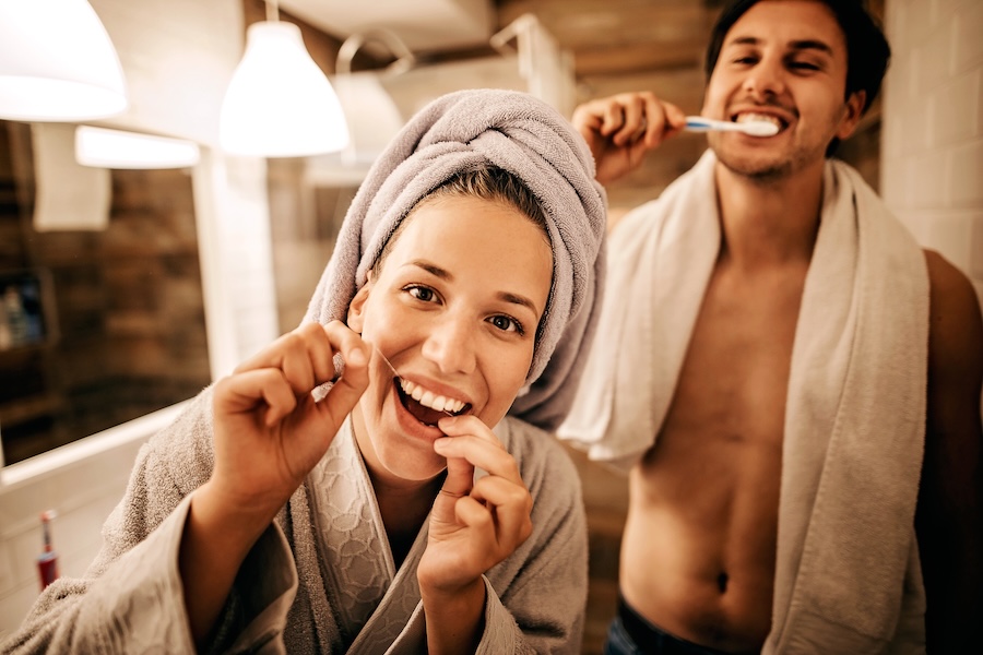 couple brushing and flossing, smile resolutions