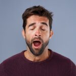 man yawning and tired after sleeping, sleep apnea treatment