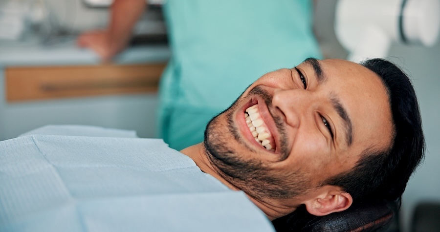 man at dental office for routine dental exam and cleaning